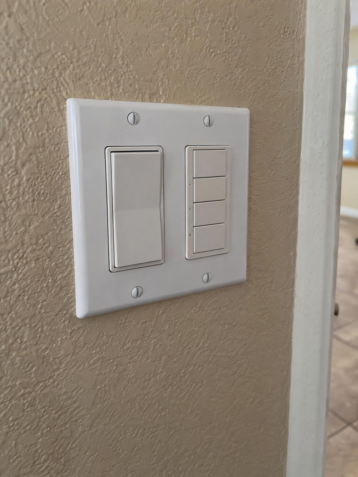 Rocker switch next to a fan and light control