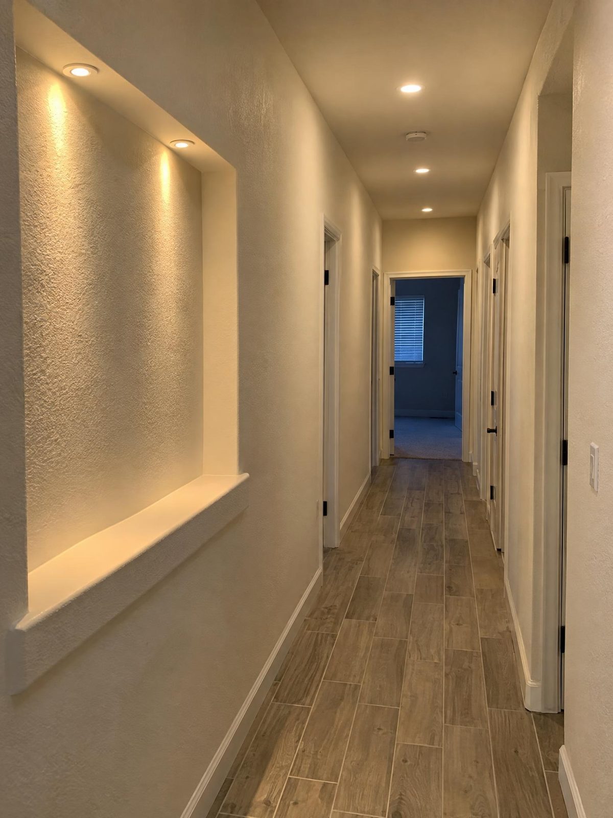 Hallway with recessed accent lighting in a wall niche